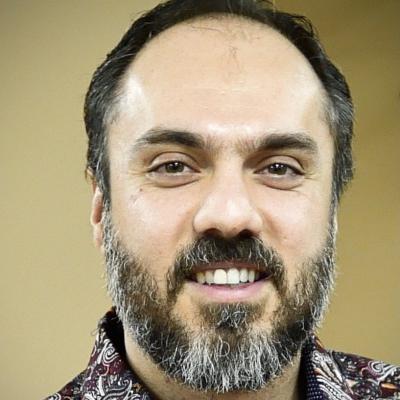 Dr. Keramatian has short hair hair and beard.