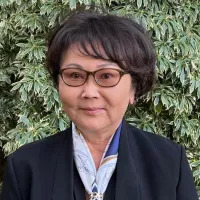 headshot of Dr Joanne Matsubara. Black short hair and black framed glasses