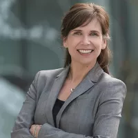 Headshot of Dr. Quandt. She has long brown hair and is wearing a grey suit.