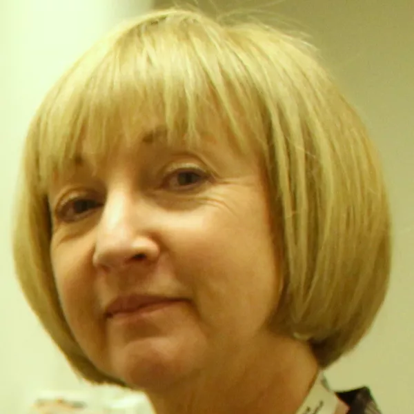 Dr. Deborah Giaschi has chin-length blond hair with bangs